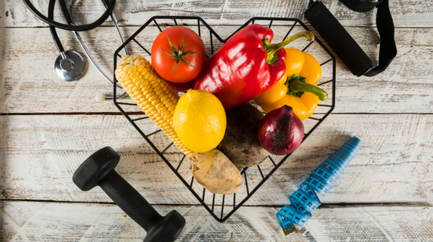 fresh-vegetables-surrounded-by-fitness-equipments-stethoscope-measuring-tape (1)